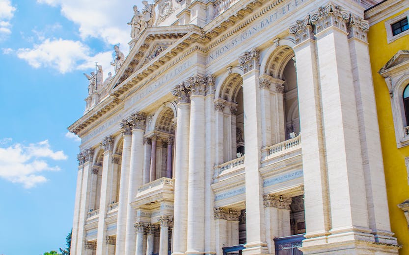 St. John Lateran Basilica facade with visitors in Rome, Italy.