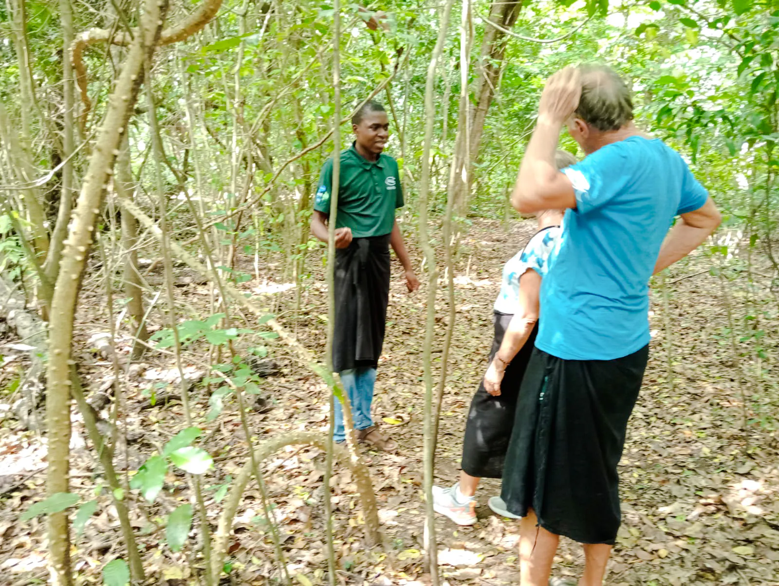 Guide leading a tour in Kaya Kinondo Forest, Diani Beach.