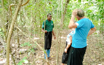 Guide leading a tour in Kaya Kinondo Forest, Diani Beach.
