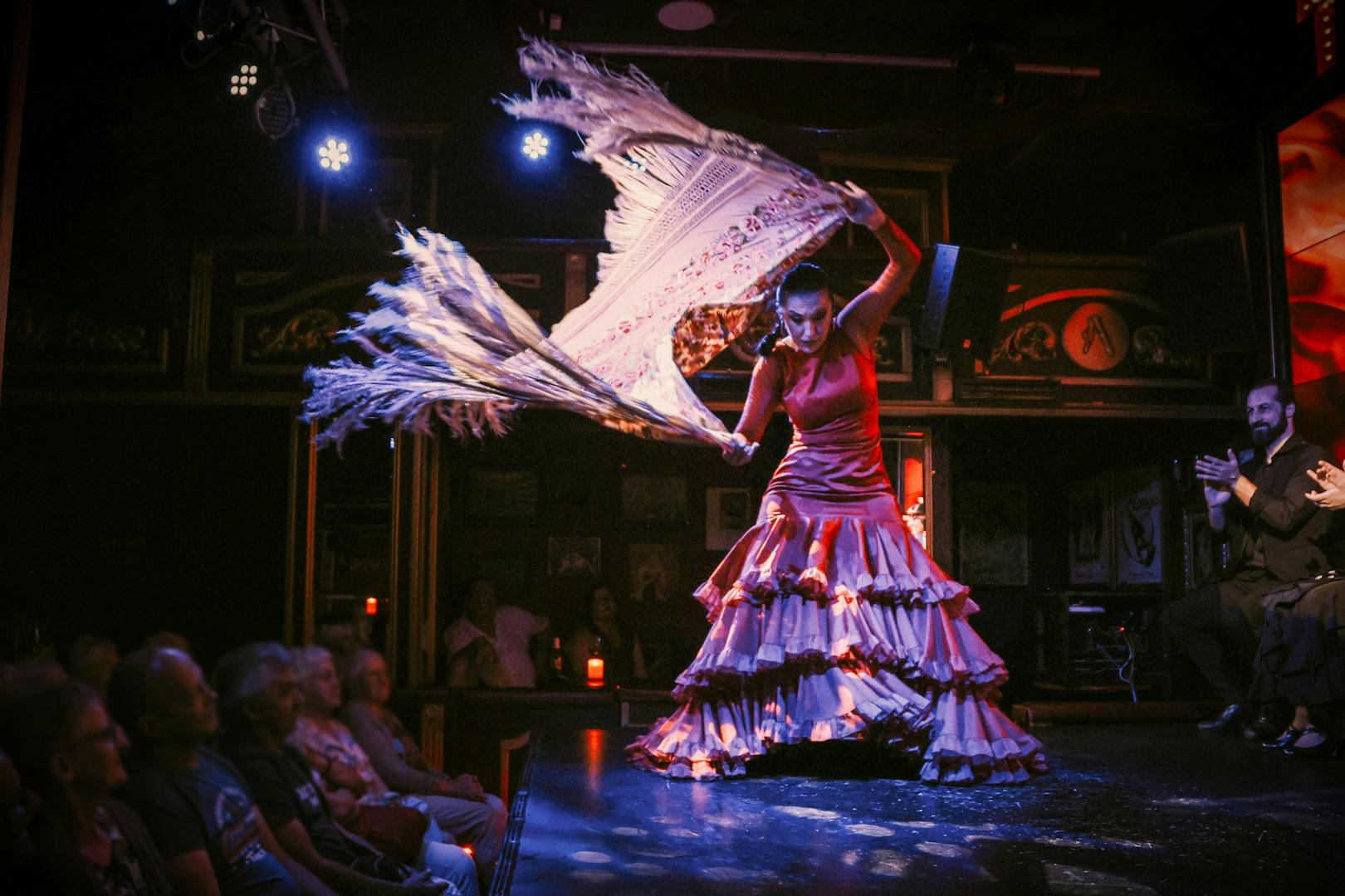 Flamenco dancer performing at Teatro Flamenco Málaga Club with audience watching.