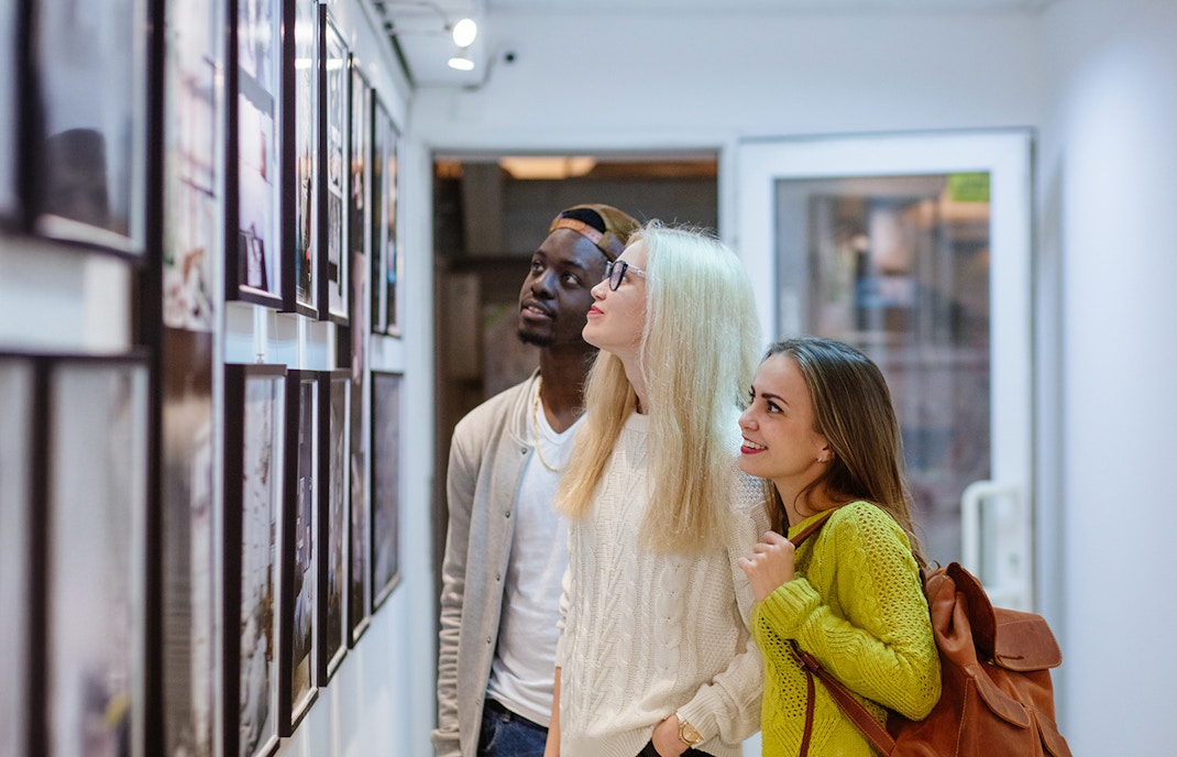 Visitors viewing wildlife photography at the Wildlife Photographer of the Year exhibition, London.
