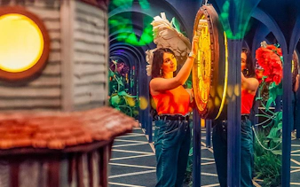 Visitor exploring interactive exhibit at Big Fun Museum & Museum of Illusions.