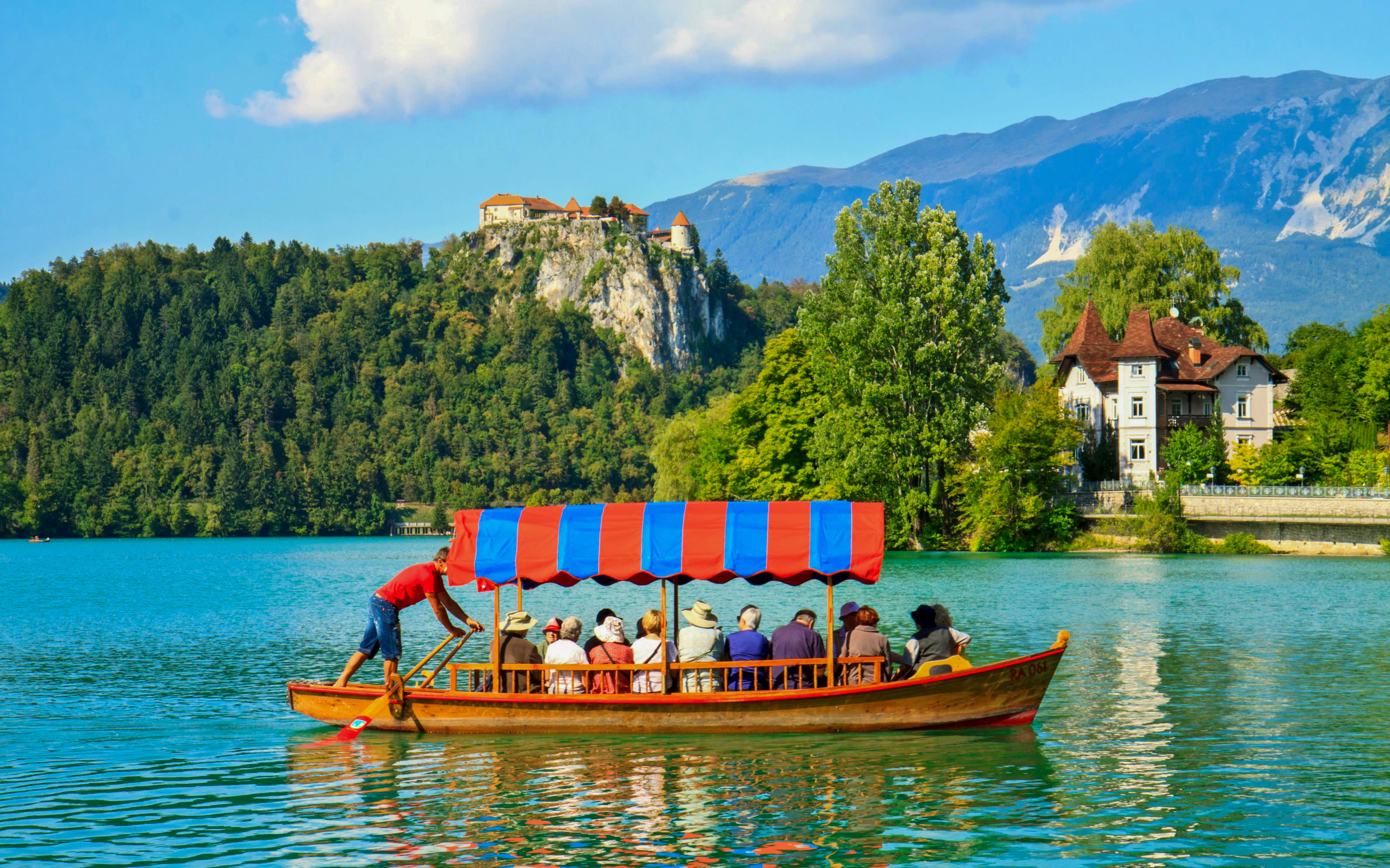 Boat on Lake Bled with Bled Castle in the background, Slovenia.