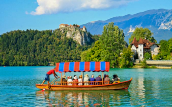 Boat on Lake Bled with Bled Castle in the background, Slovenia.