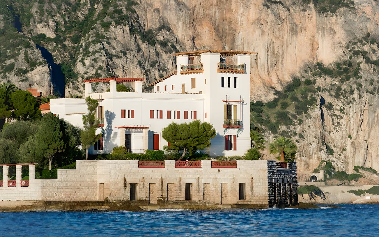 Villa Kerylos by the sea with rocky cliffs in Beaulieu-sur-Mer, France.