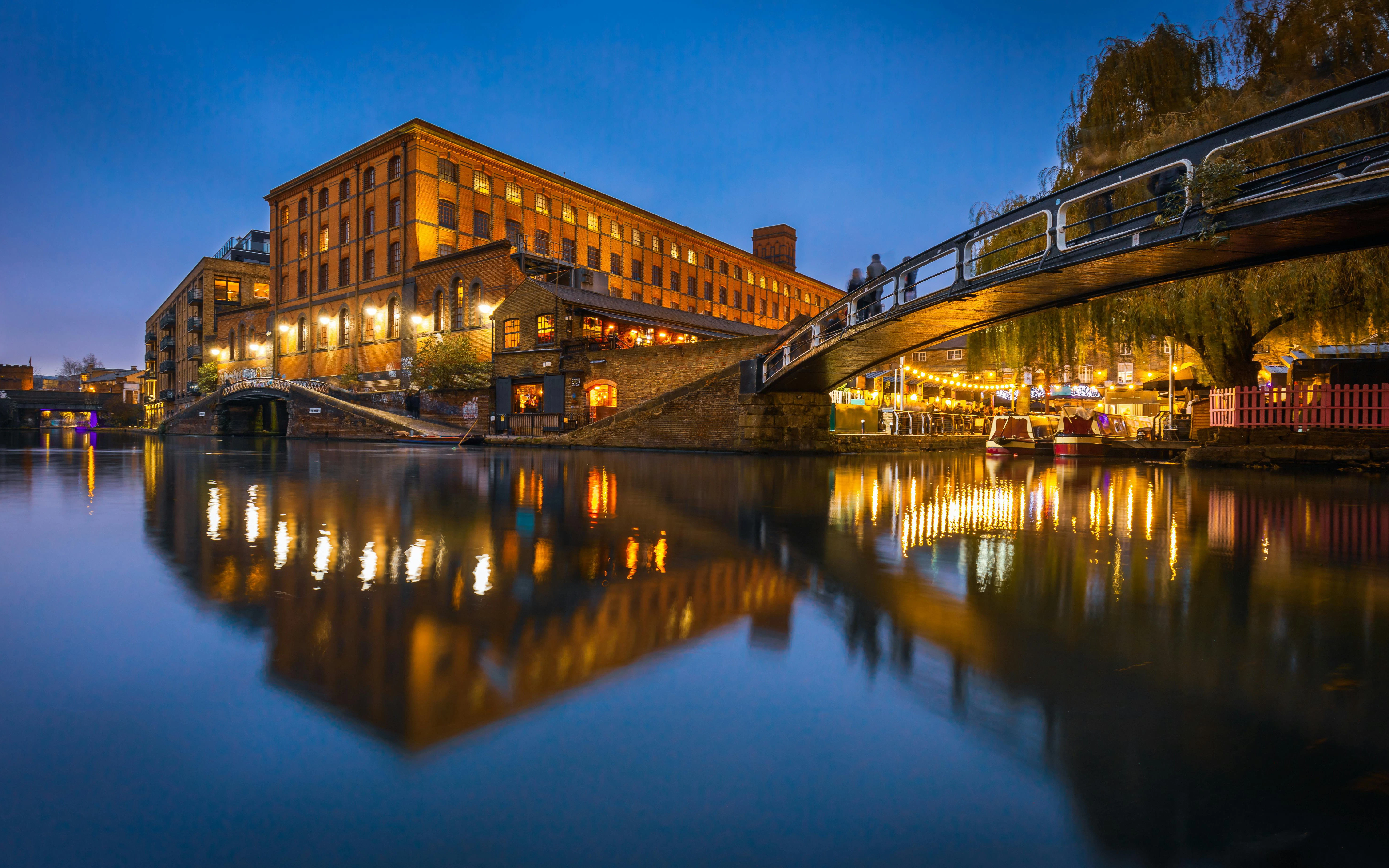 Camden Lock at dusk with illuminated buildings and bridge, London, United Kingdom.