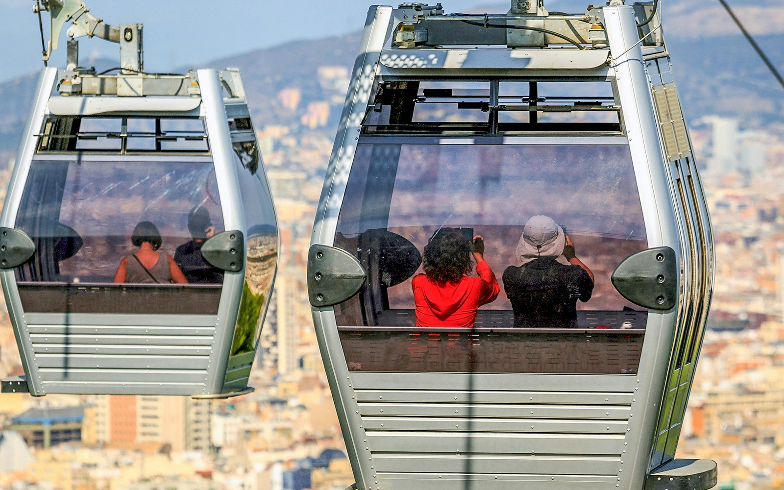 Cable car ascending Montjuic Hill with view of Sagrada Familia in back