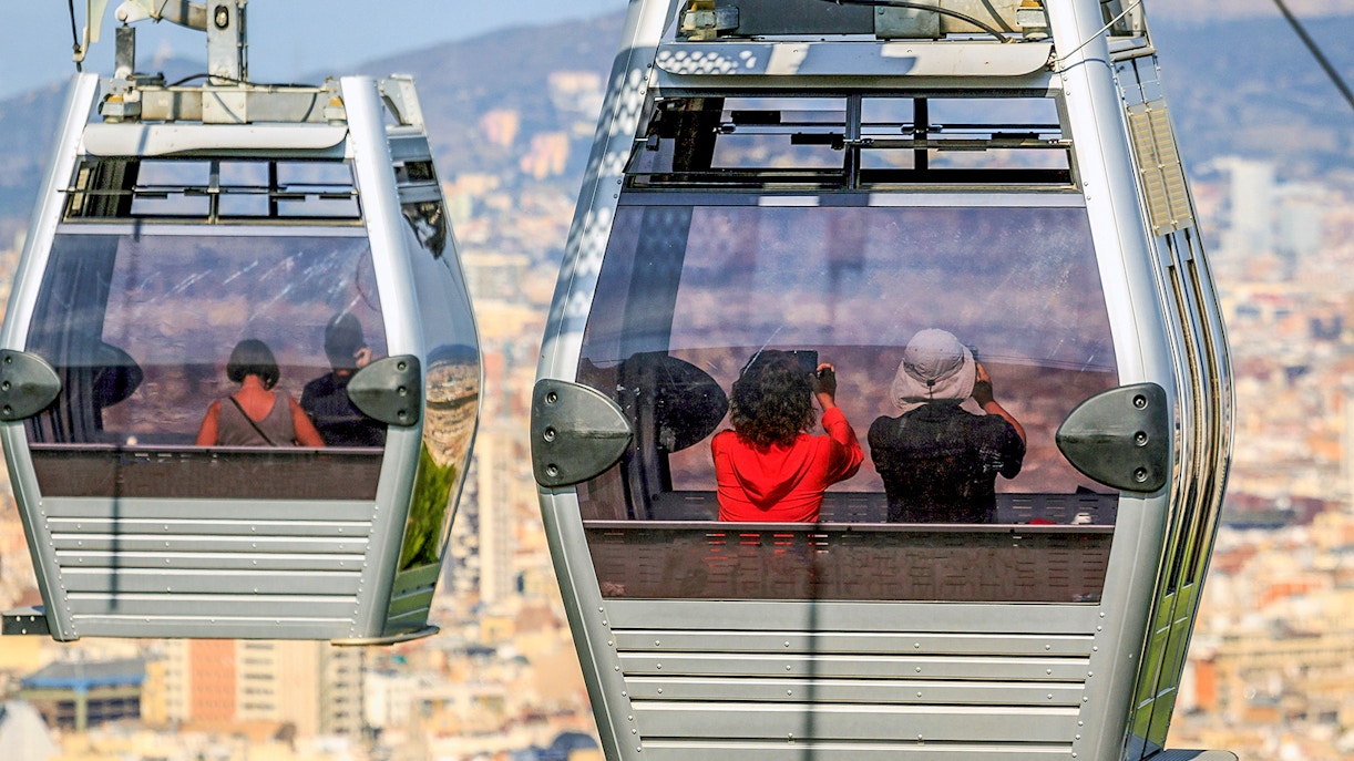 Cable car ascending Montjuic Hill with view of Sagrada Familia in back