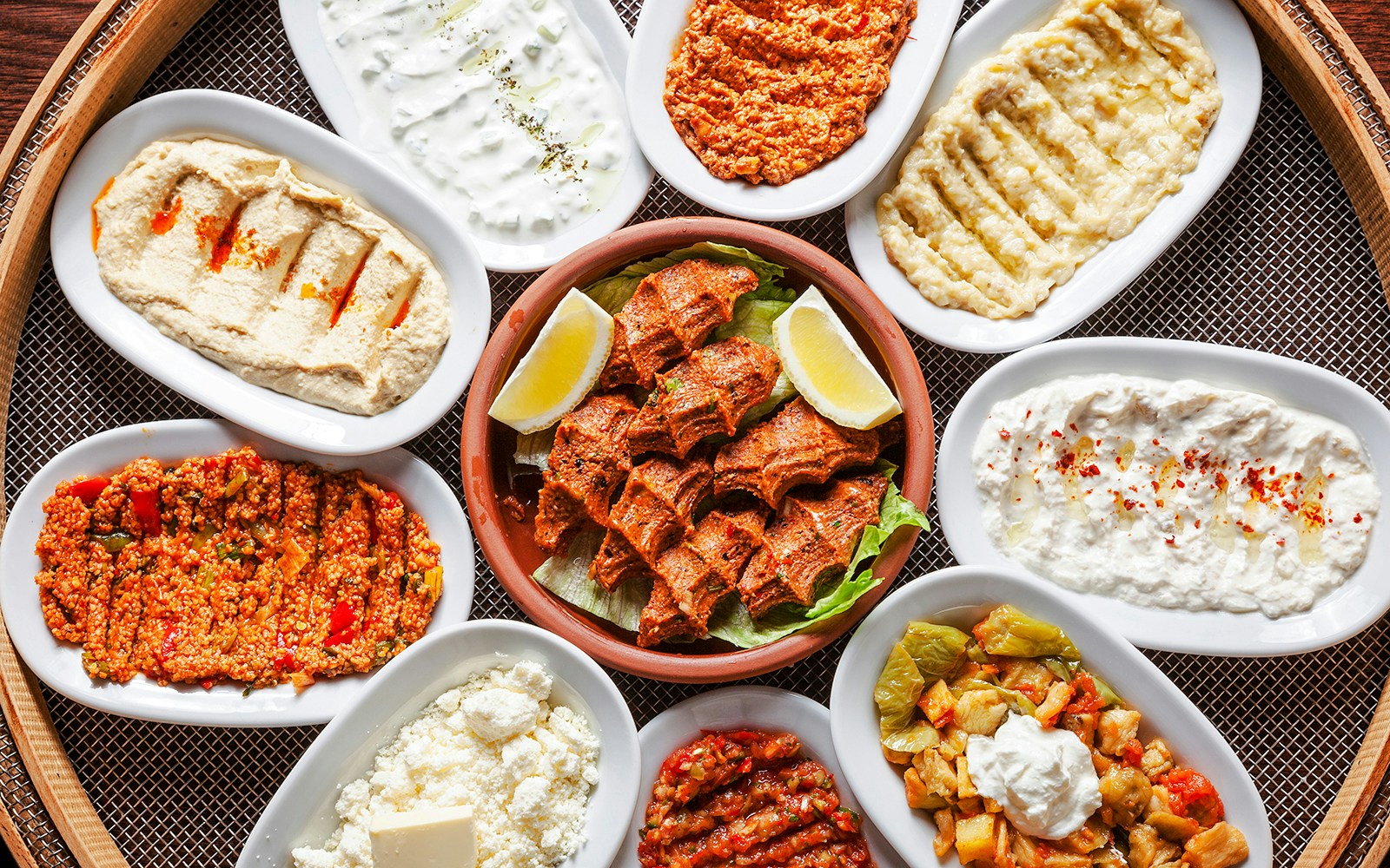 Turkish meze platter with various dishes including hummus and spicy bulgur salad.