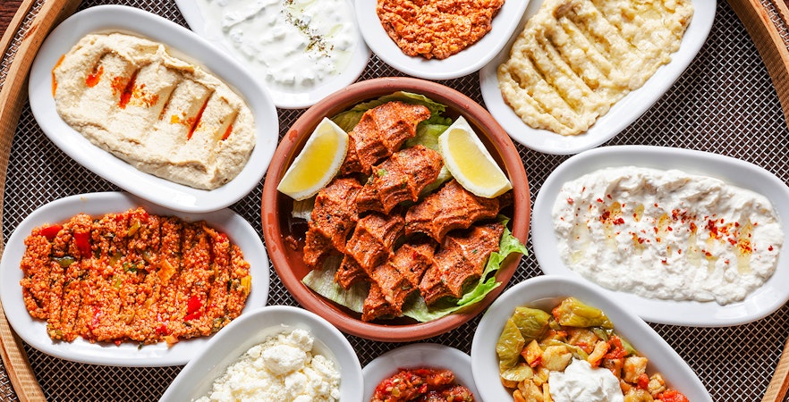 Whirling Dervishes performing in a ceremony with an audience in Istanbul.