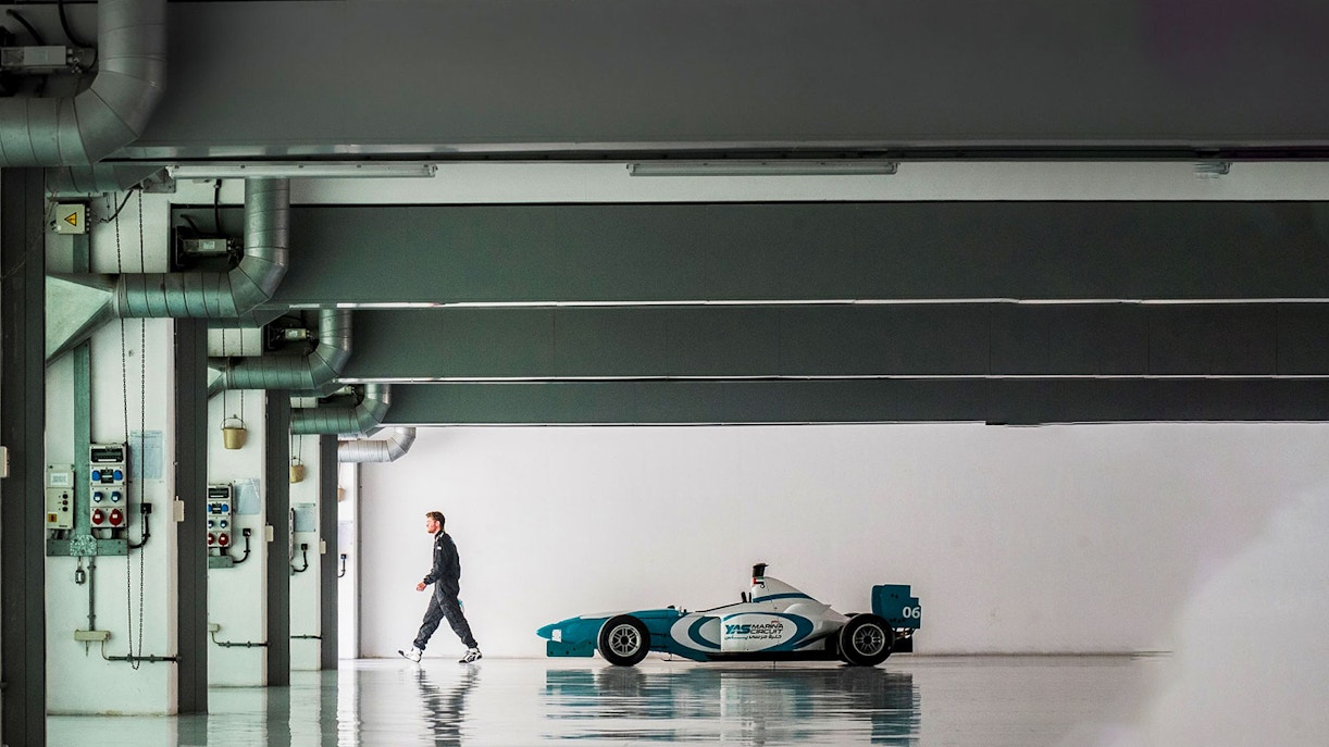 Yas Marina Circuit Formula car in a garage, Dubai driving experience.