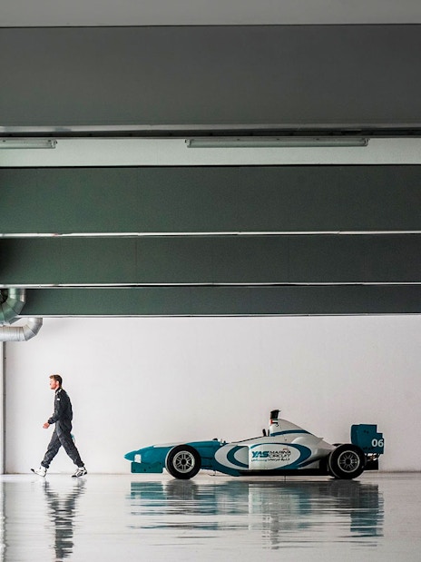 Yas Marina Circuit Formula car in a garage, Dubai driving experience.