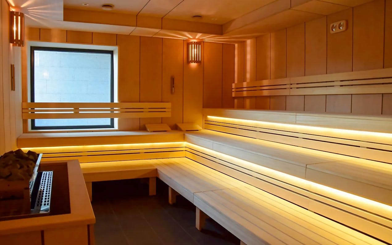 Sauna interior at Pesterzsebet Bath, Budapest with wooden benches and soft lighting.