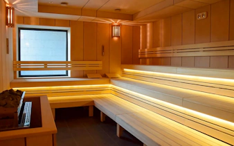 Sauna interior at Pesterzsebet Bath, Budapest with wooden benches and soft lighting.