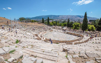 Theatre of Dionysus ruins with visitors, Acropolis, Athens, Greece.