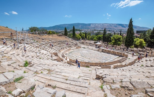 Theatre of Dionysus ruins with visitors, Acropolis, Athens, Greece.
