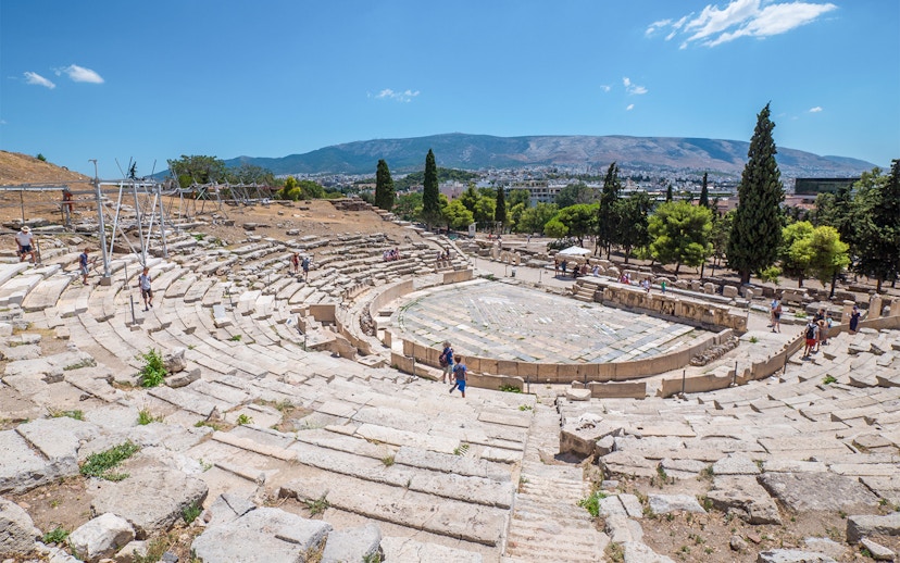 Theatre of Dionysus ruins with visitors, Acropolis, Athens, Greece.