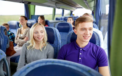 Travelers on a coach to Mount Fuji, enjoying views of cherry blossoms.