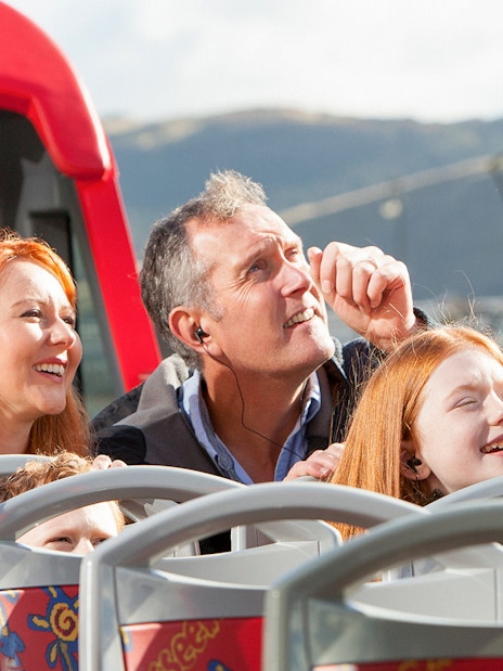 Family enjoying The Royal Edinburgh Tour on an open-top bus.