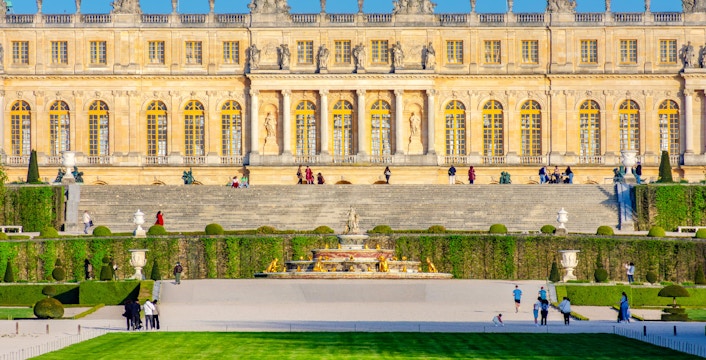Versailles Palace facade with gardens and fountain, Jardin des Etangs Gobert, France.