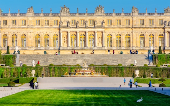 Versailles Palace facade with gardens and fountain, Jardin des Etangs Gobert, France.
