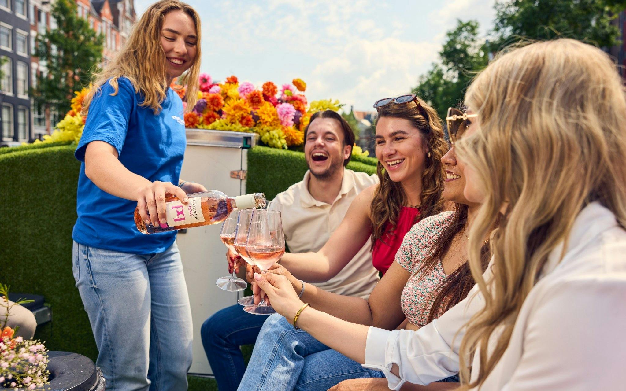 Guests enjoying wine on a luxury flower boat during a city highlights cruise.