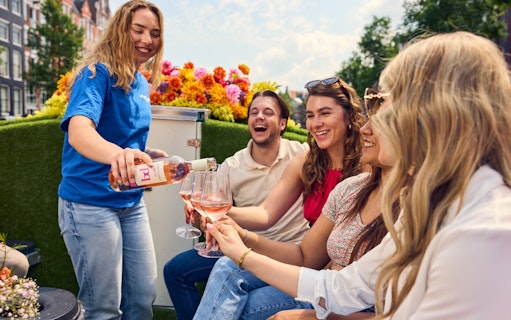 Guests enjoying wine on a luxury flower boat during a city highlights cruise.