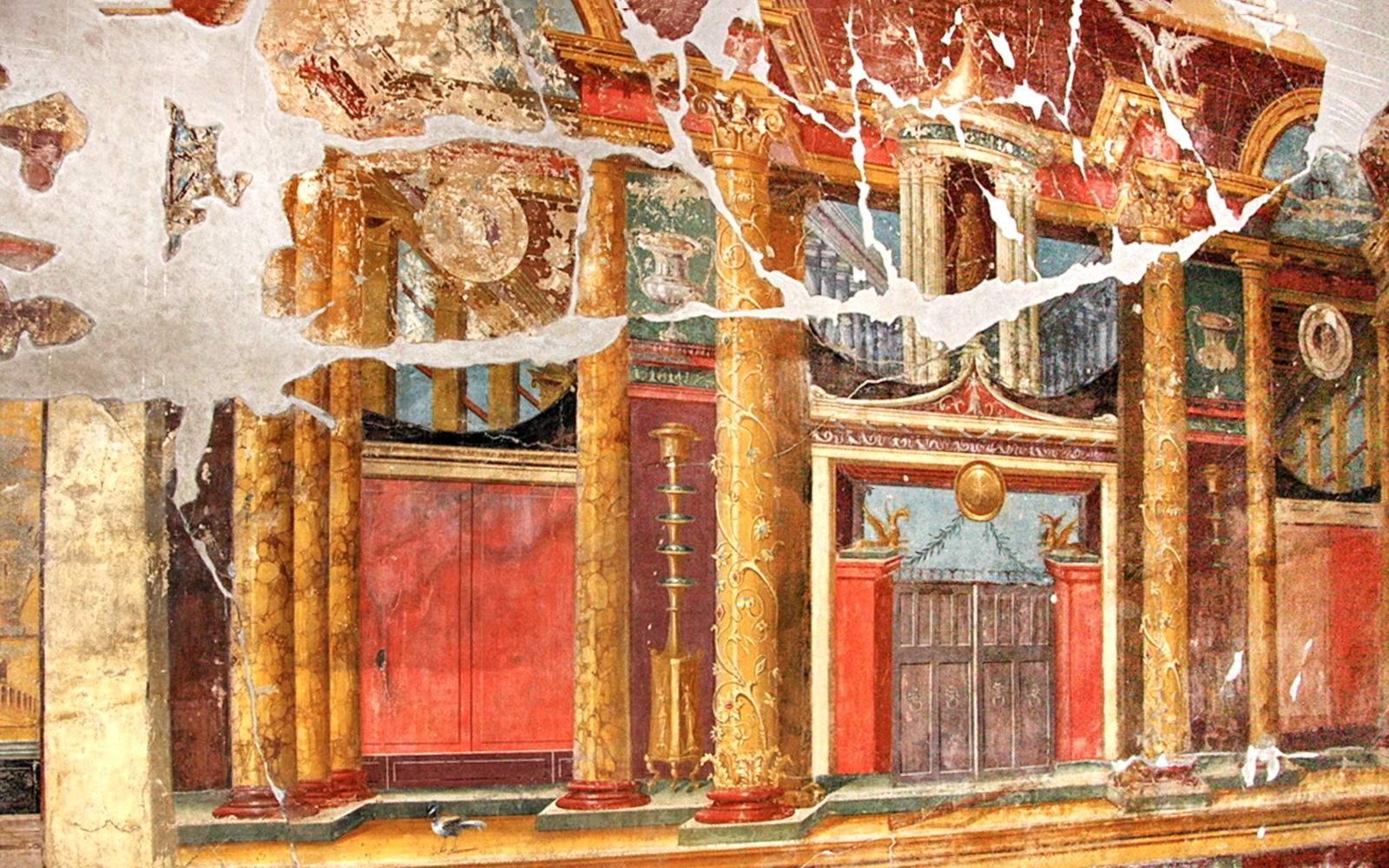 Wall fresco in Oplontis depicting ornate columns and architectural details.