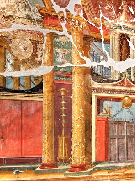 Wall fresco in Oplontis depicting ornate columns and architectural details.