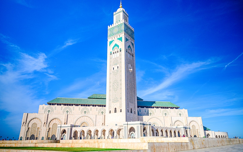 Hassan II Mosque in Casablanca with its tall minaret against a clear blue sky.