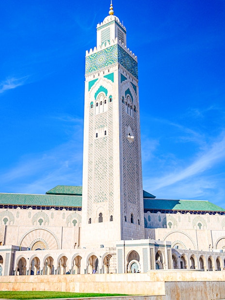 Hassan II Mosque in Casablanca with its tall minaret against a clear blue sky.