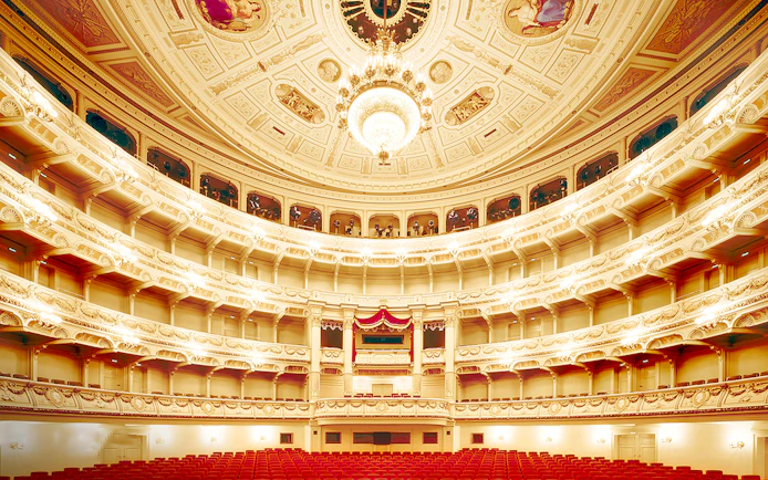 Semperoper Opera House interior with ornate balconies and chandelier, Dresden.