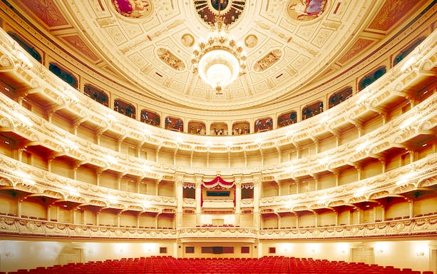 Semperoper Opera House interior with ornate balconies and chandelier, Dresden.