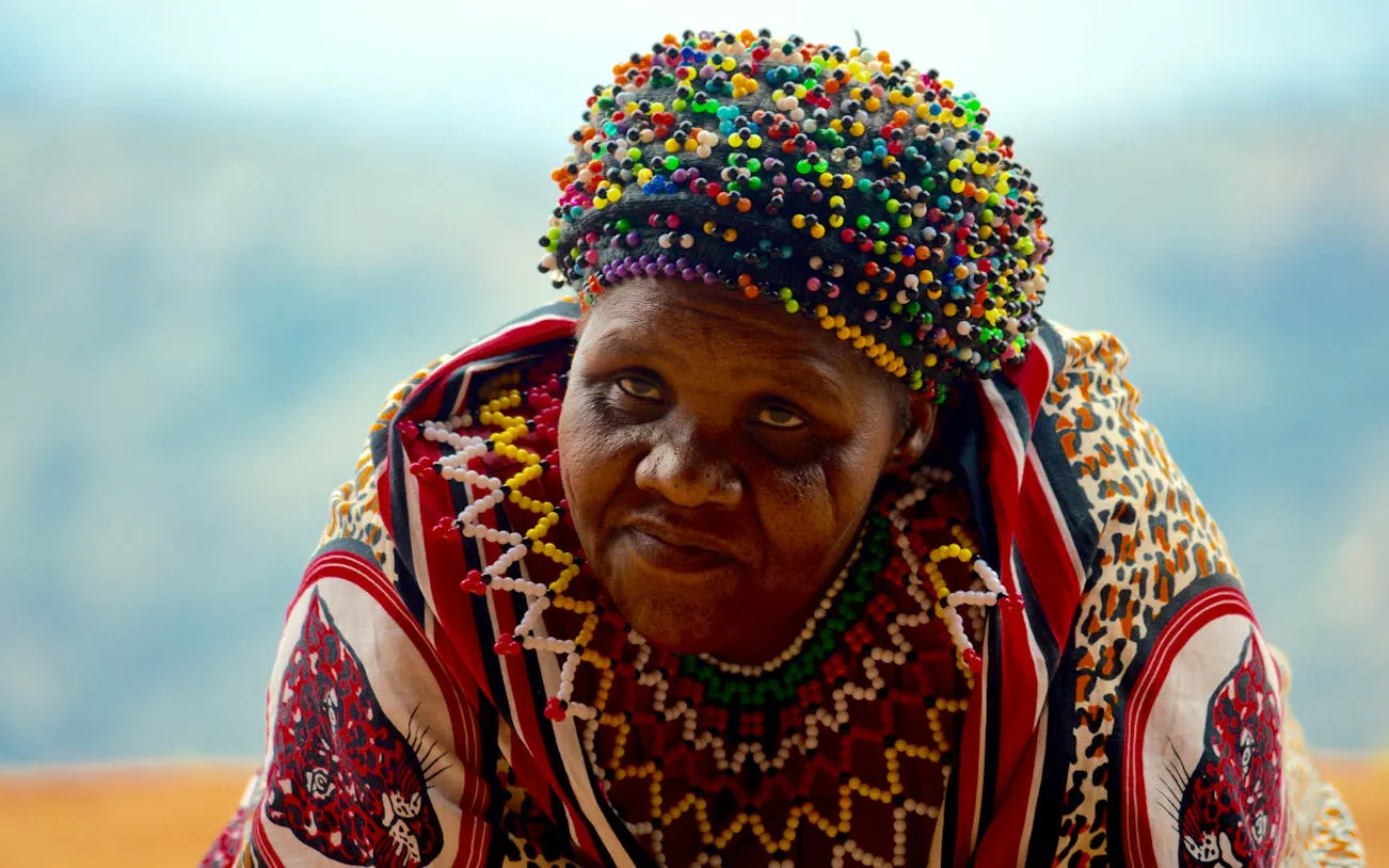 Zulu woman in traditional attire at PheZulu Cultural Village during Mandela Capture Site tour.
