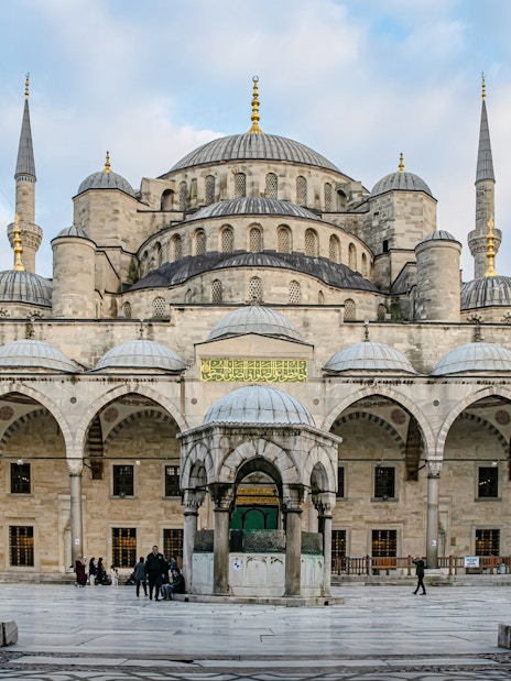 Blue Mosque courtyard with central fountain and domes, Istanbul.