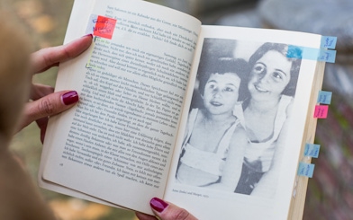 Open Anne Frank's diary with a photo of Anne and Margot, Amsterdam.