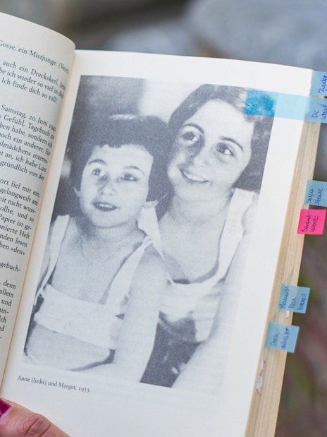 Open Anne Frank's diary with a photo of Anne and Margot, Amsterdam.