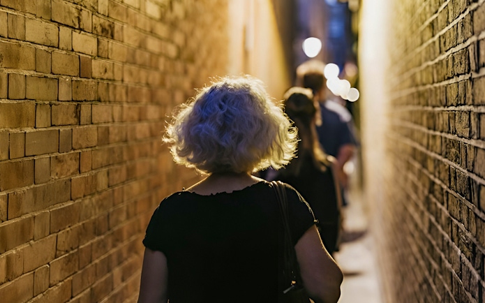 Walking through narrow London alley on Harry Potter film locations tour.