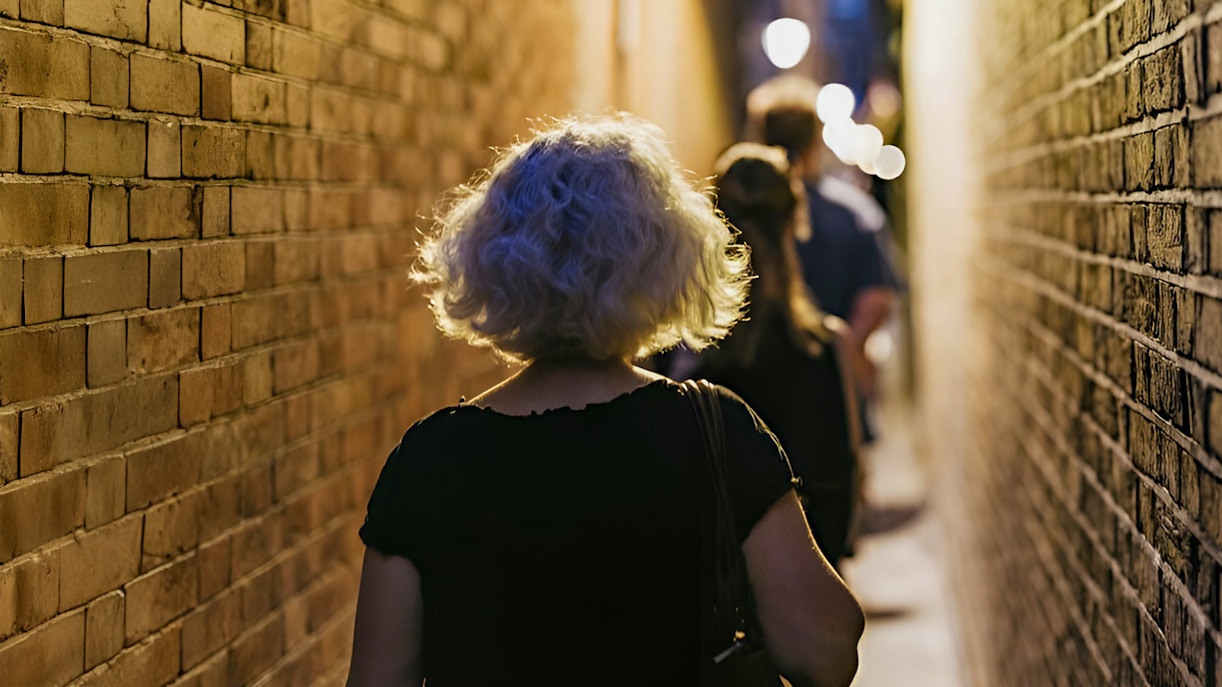 Walking through narrow London alley on Harry Potter film locations tour.