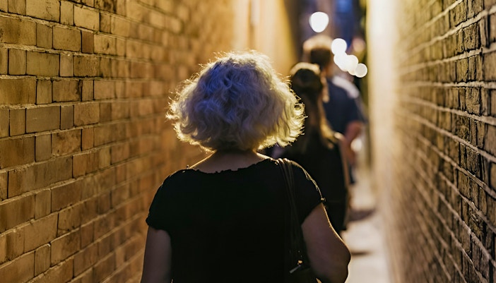 Walking through narrow London alley on Harry Potter film locations tour.