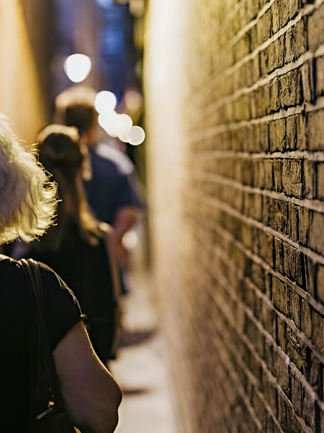 Walking through narrow London alley on Harry Potter film locations tour.