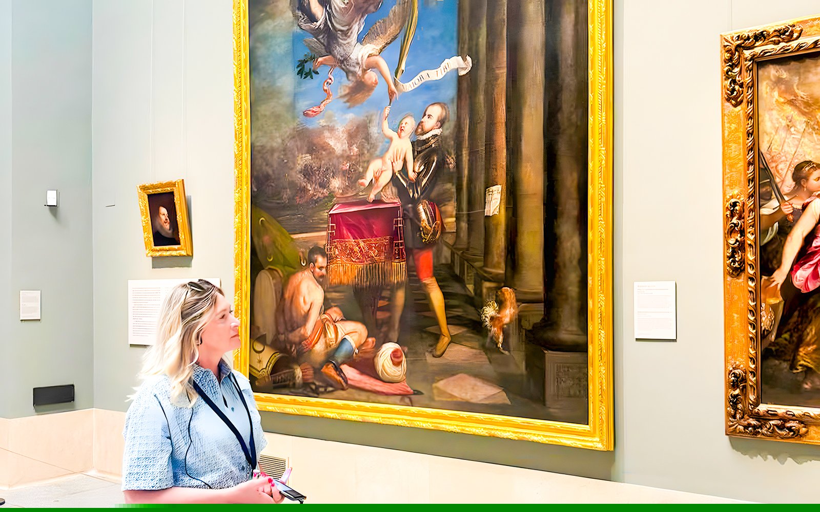 Visitor admiring a large Renaissance painting in a museum gallery.