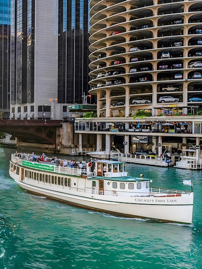 Chicago Riverwalk with 'Chicago's First Lady' tour boat passing by Marina City.