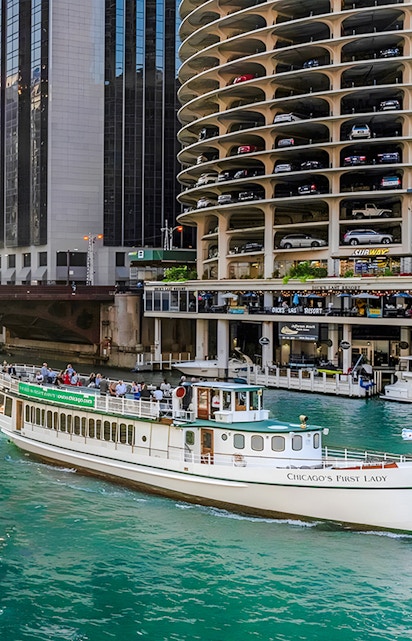 Chicago Riverwalk with 'Chicago's First Lady' tour boat passing by Marina City.