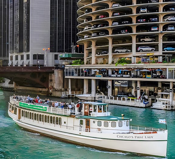 Chicago Riverwalk with 'Chicago's First Lady' tour boat passing by Marina City.