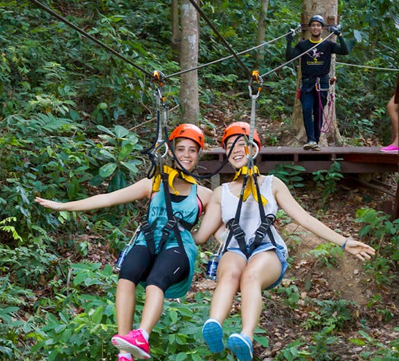 Visitors ziplining through the forest at Hanuman World, Thailand.