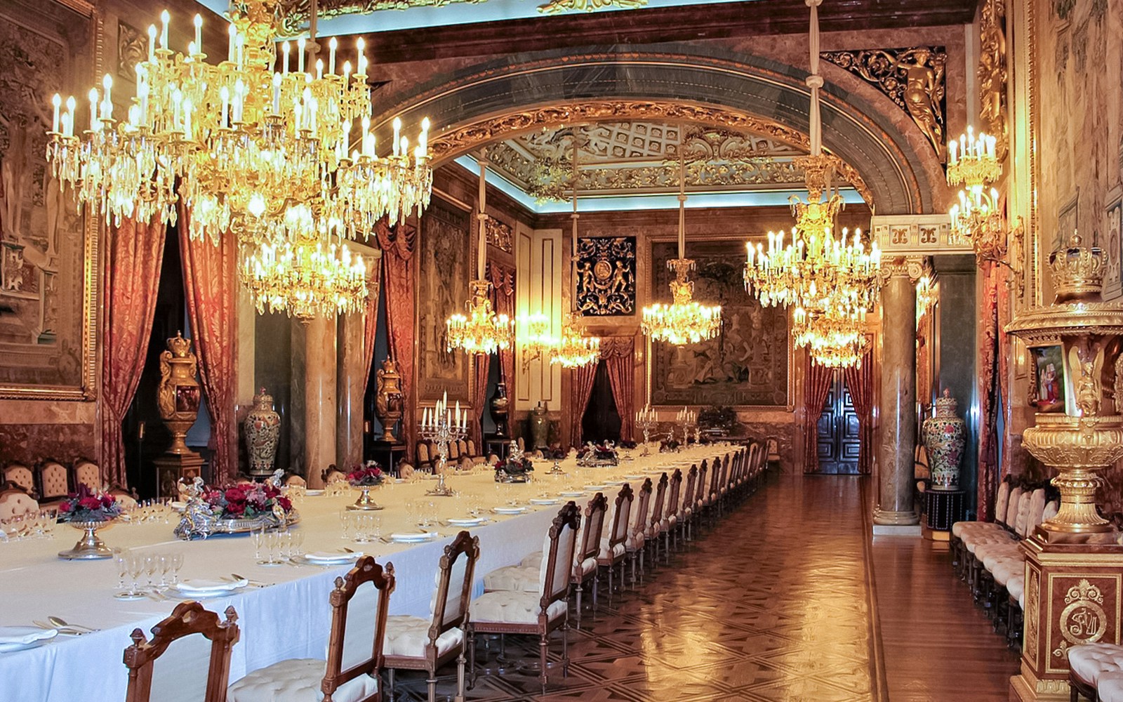 Gala dining room with ornate chandeliers and tapestries, Royal Palace of Madrid.