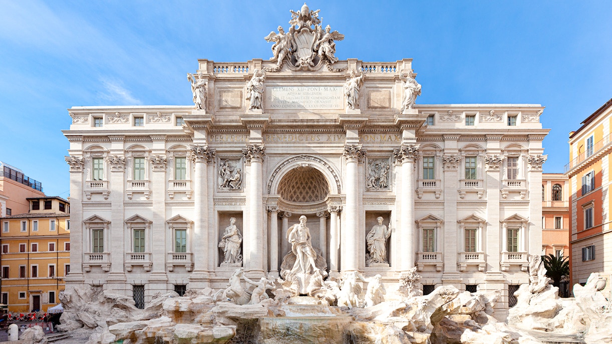 Trevi Fountain in Rome with ornate sculptures and flowing water.