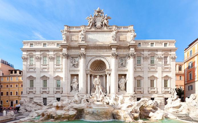 Trevi Fountain in Rome with ornate sculptures and flowing water.