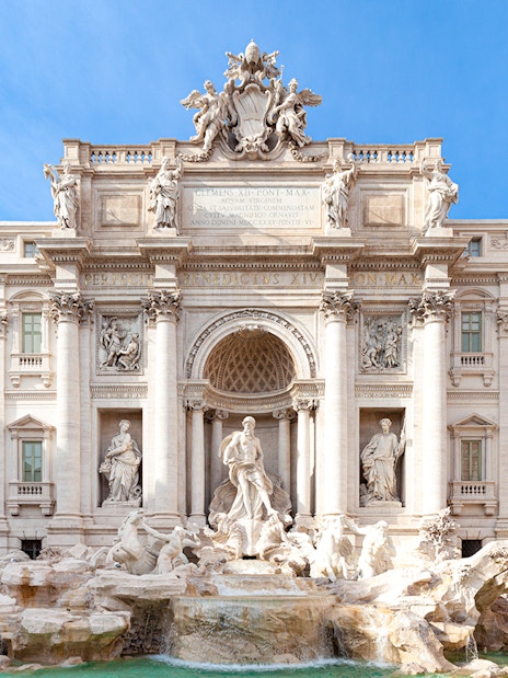 Trevi Fountain in Rome with ornate sculptures and flowing water.